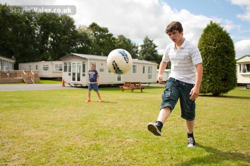 Kids playing some footie at Woodland Park - Vale Holiday Parks