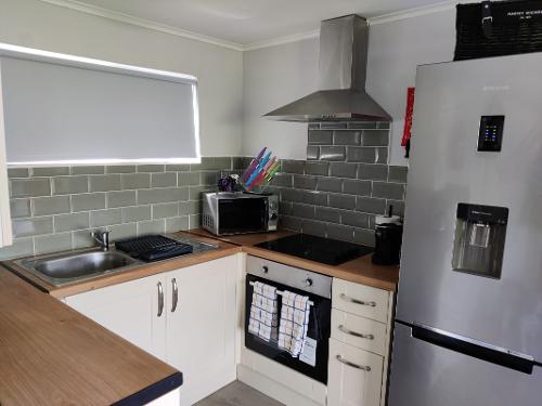 Kitchen with microwave, oven and fridge freezer