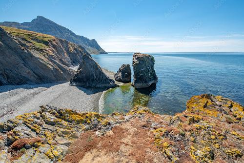 Three craggy rocks in a bay
