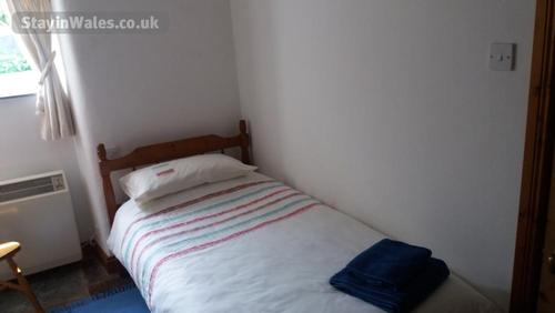 smaller bedroom has two single beds