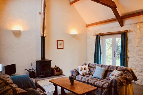 comfy sofas, french windows and wood stove.